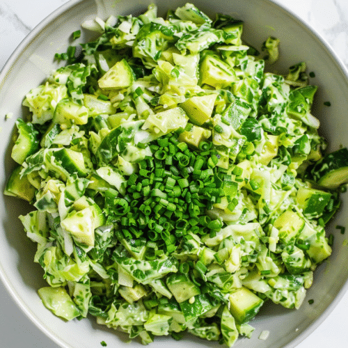 Close-up of Green Goddess Salad with glistening green dressing